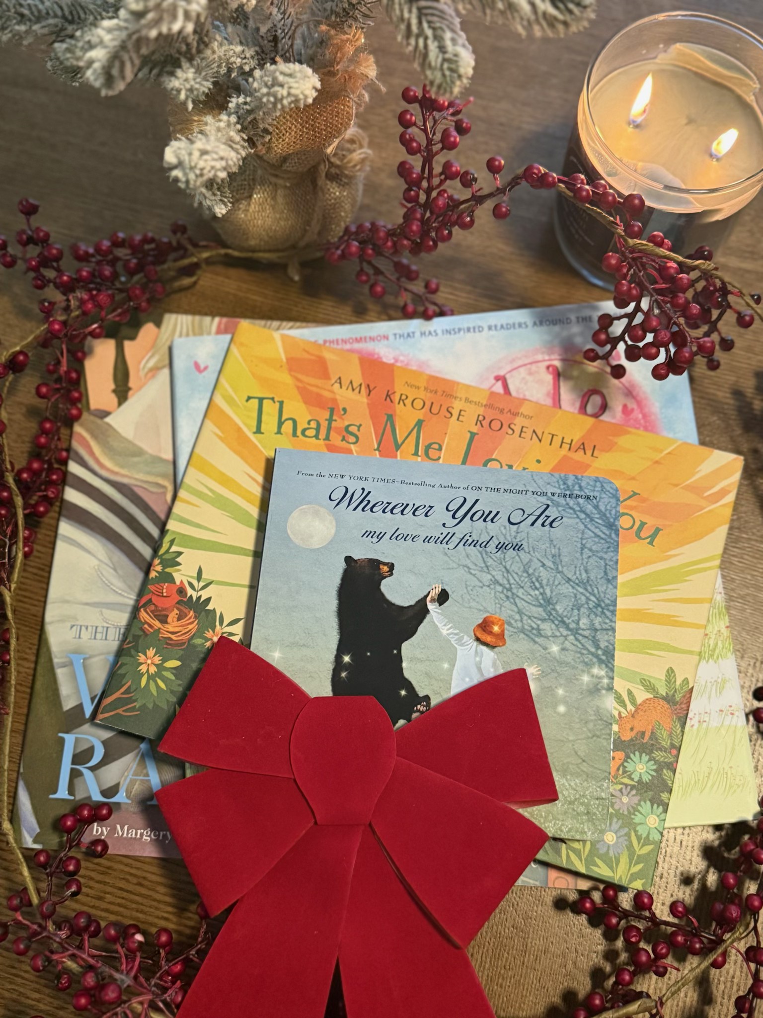 Ruby's Reading Circle books wrapped with a red bow beside a candle